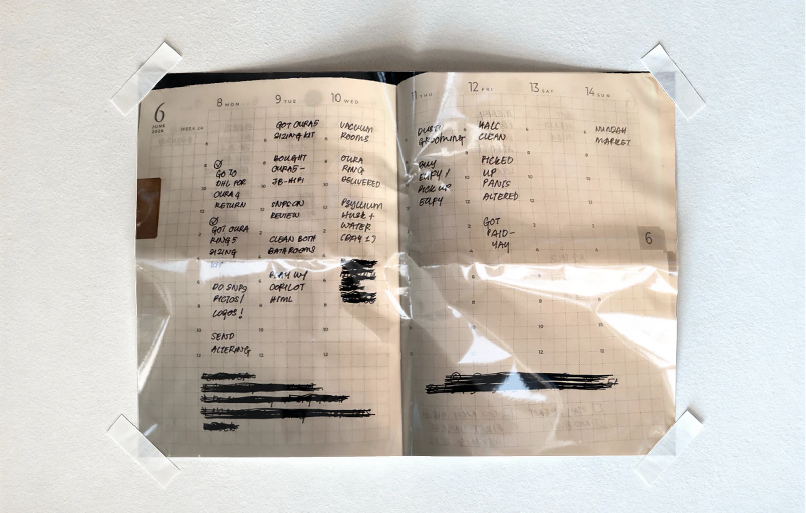 A weekly paper diary open to a week, Monday to Sunday, filled in by hand — the task system that came before the app.